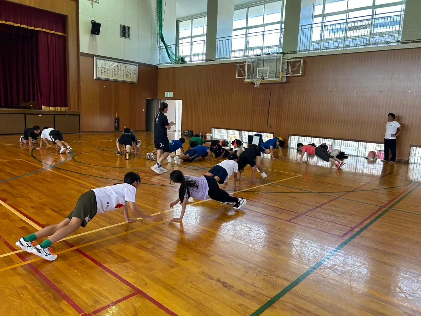 体育館で体幹を意識したトレーニングに取り組む参加者